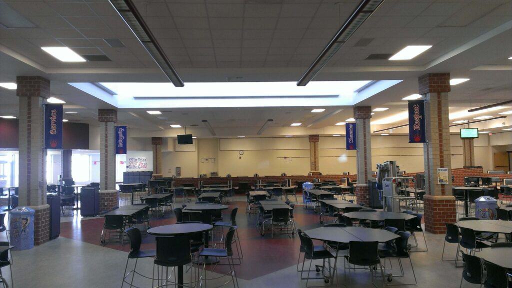 Hanging school banners in cafeteria.