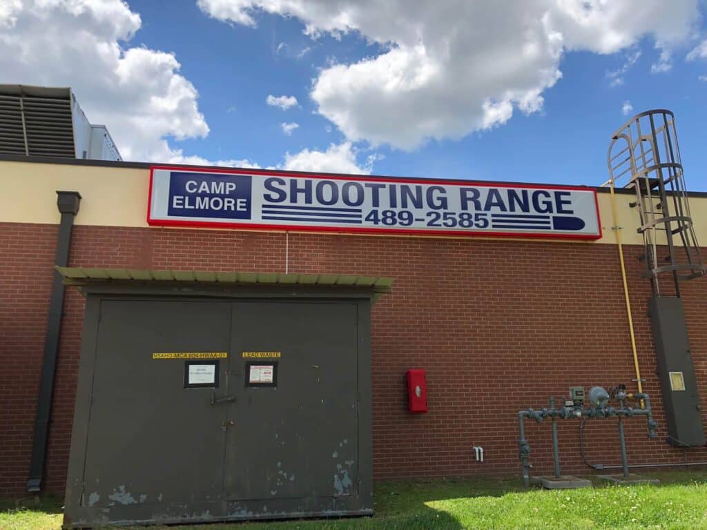 Shooting Range sign mounted on building for Camp Elmore Shooting Range sign mounted on building for Camp Elmore