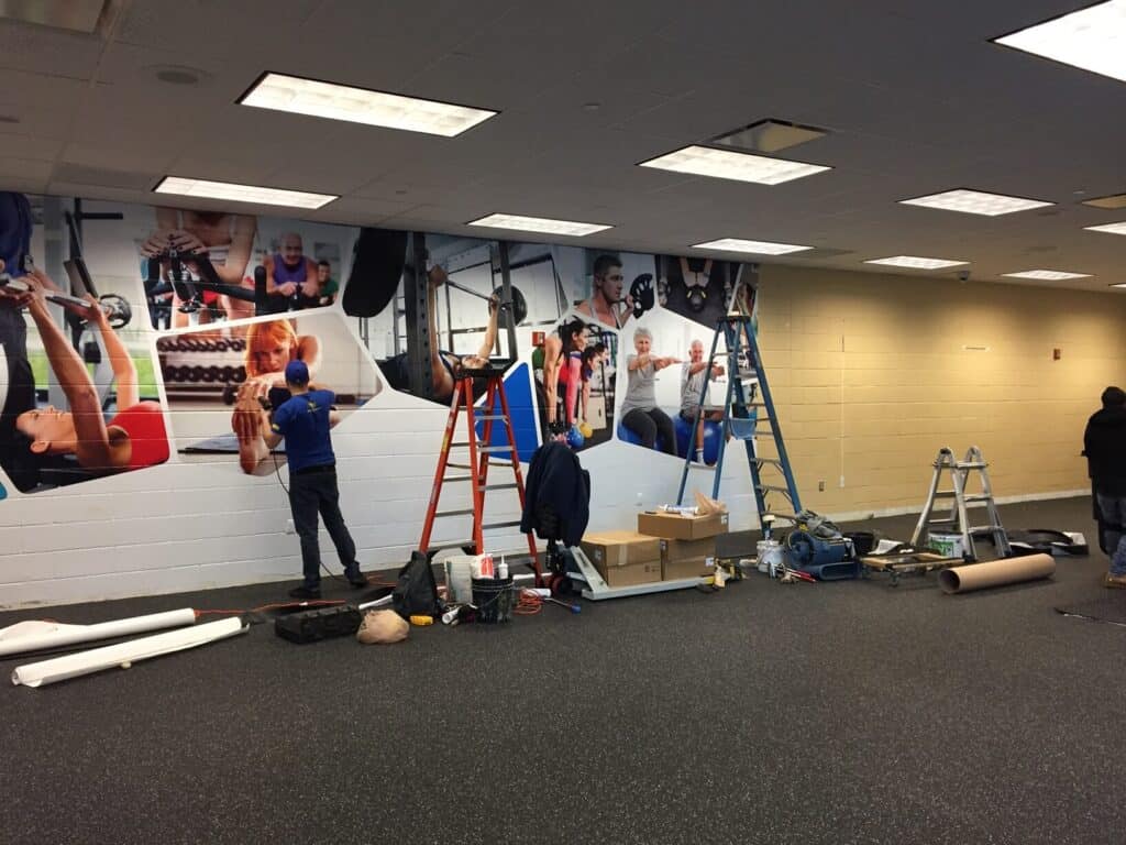 Gym wall mural installation by DeSigns Inc.
