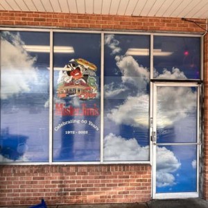 Perforated window film graphics allows in light and offers privacy and security.