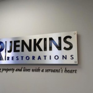 Brush metal style mounted lobby sign by DeSigns, Inc.