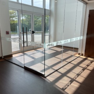 Etch glass film in office foyer by DeSigns, Inc. Visually protect your glass entrance. Helps people see there is glass using etched graphics.
