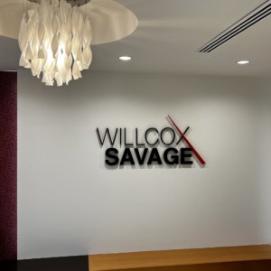 Logos mounted on office lobby walls - Fabricated metal letters for reception by DeSigns, Inc.