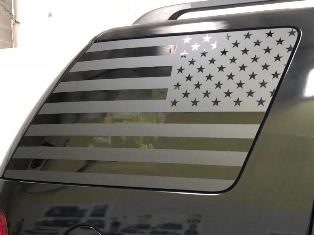 Matte black flag wrap on rear side windows of SUV glass